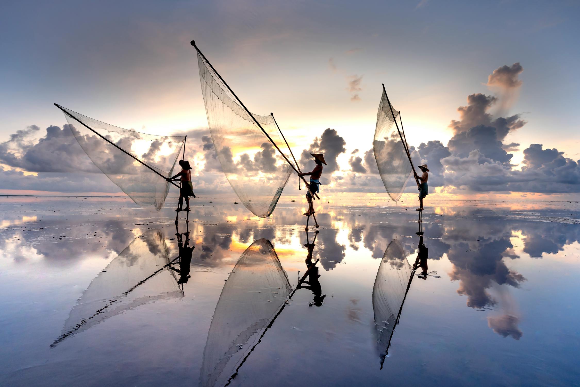 Men Throwing a Fishing Net in Sea at Dusk ©Quang Nguyen Vinh